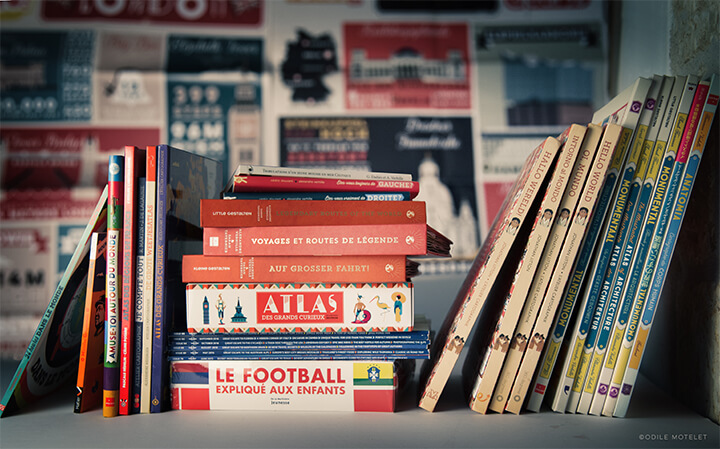 Pile of Illustrative Books tha hired Atelier Cartographik